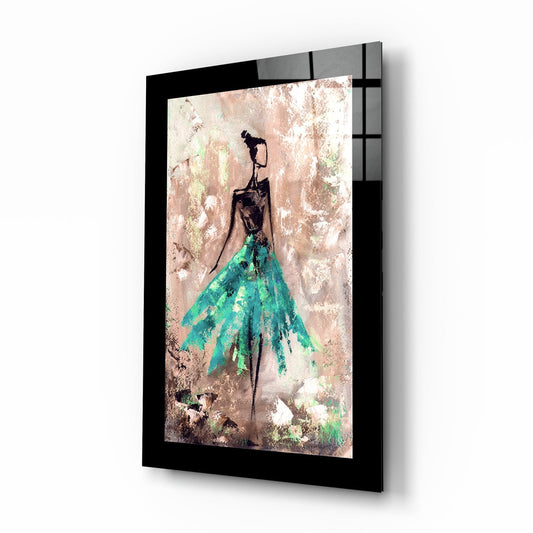 Framed glass wall art displaying a stylized figure with black upper body and flowing teal skirt against a distressed textured background, shown at an angled perspective.
