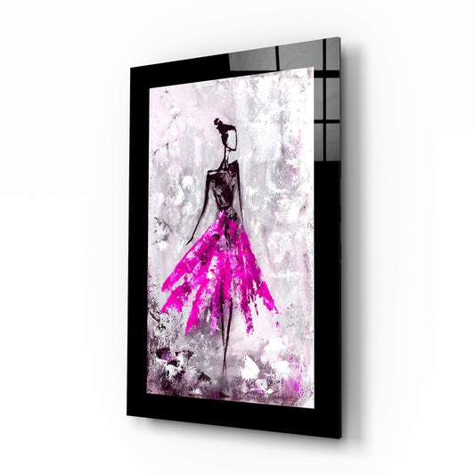 Black-framed glass wall art displaying a stylized figure with magenta skirt and dark silhouette against textured white background, shown at three-quarter angle.