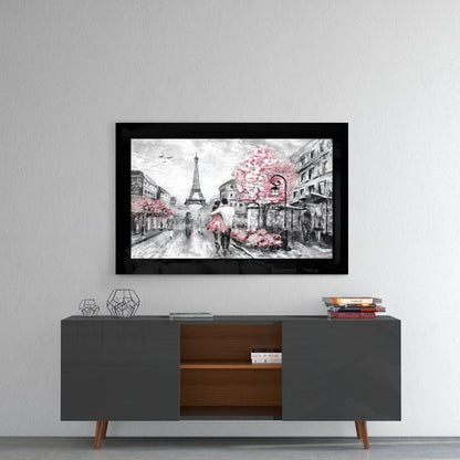 Black-framed glass wall art depicting a Paris street scene with Eiffel Tower and pink flowering trees mounted above a mid-century modern console table.