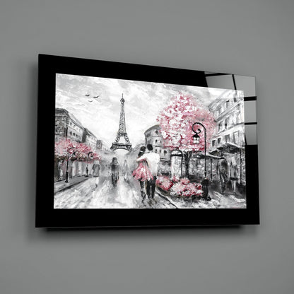 Black-framed glass wall art displaying a Paris street scene with Eiffel Tower in grayscale and pink flowering trees, mounted on gray wall.
