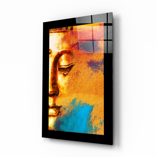 Black-framed glass wall art displaying a Buddha profile with gold, orange, and blue painted layers in a 3/4 perspective view showing depth and shadow.
