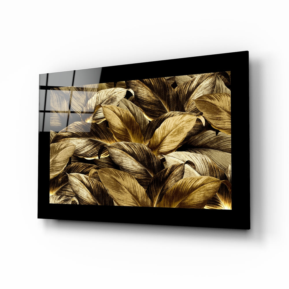 Black-framed glass wall art displaying close-up golden and brown leaf details in perspective view.
