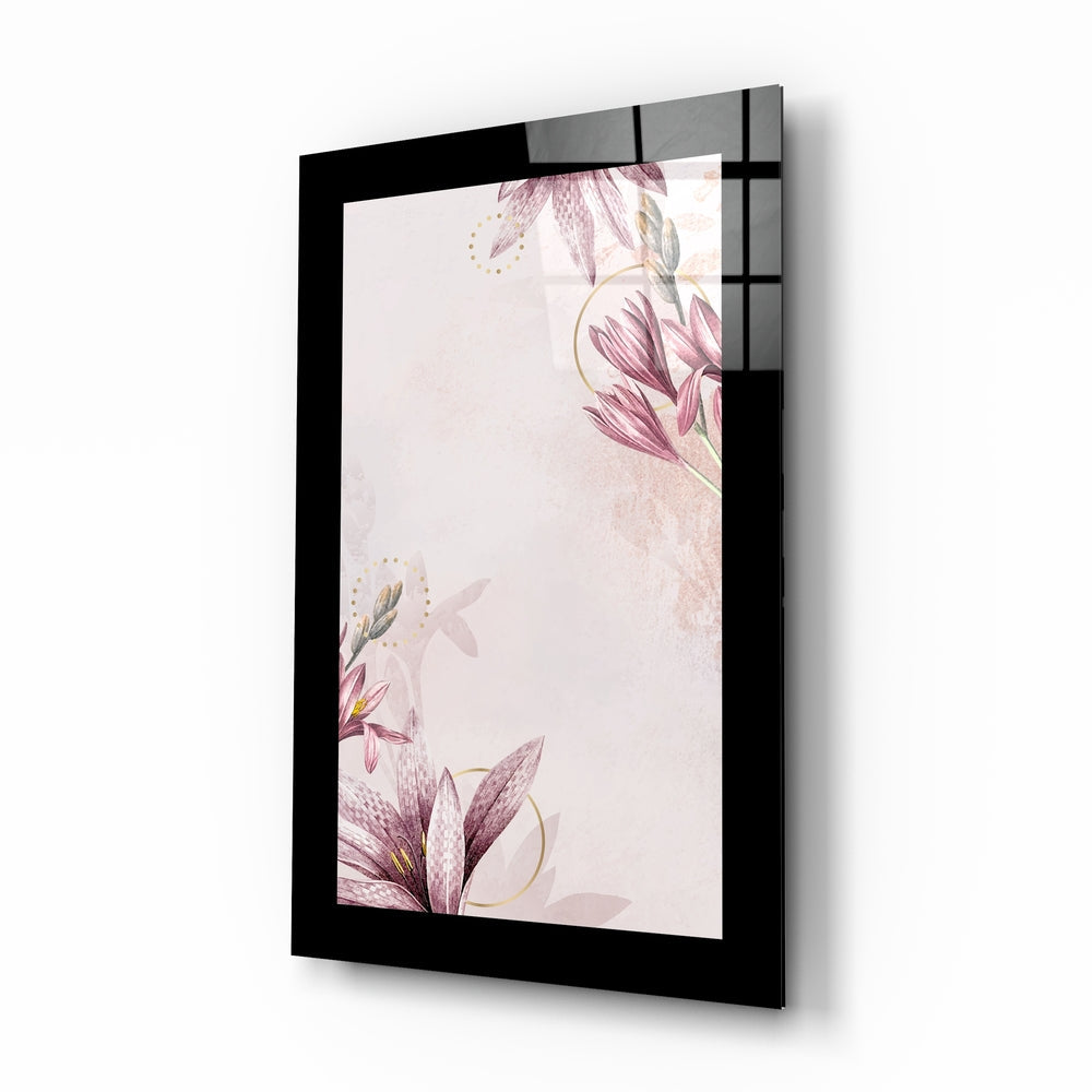 Black-framed glass wall art displaying pink floral botanical design with gold accents on cream background, angled perspective view.