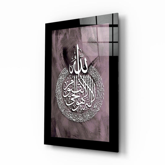 Angled perspective view of framed glass wall art displaying white Arabic calligraphy on mauve textured background with black frame.