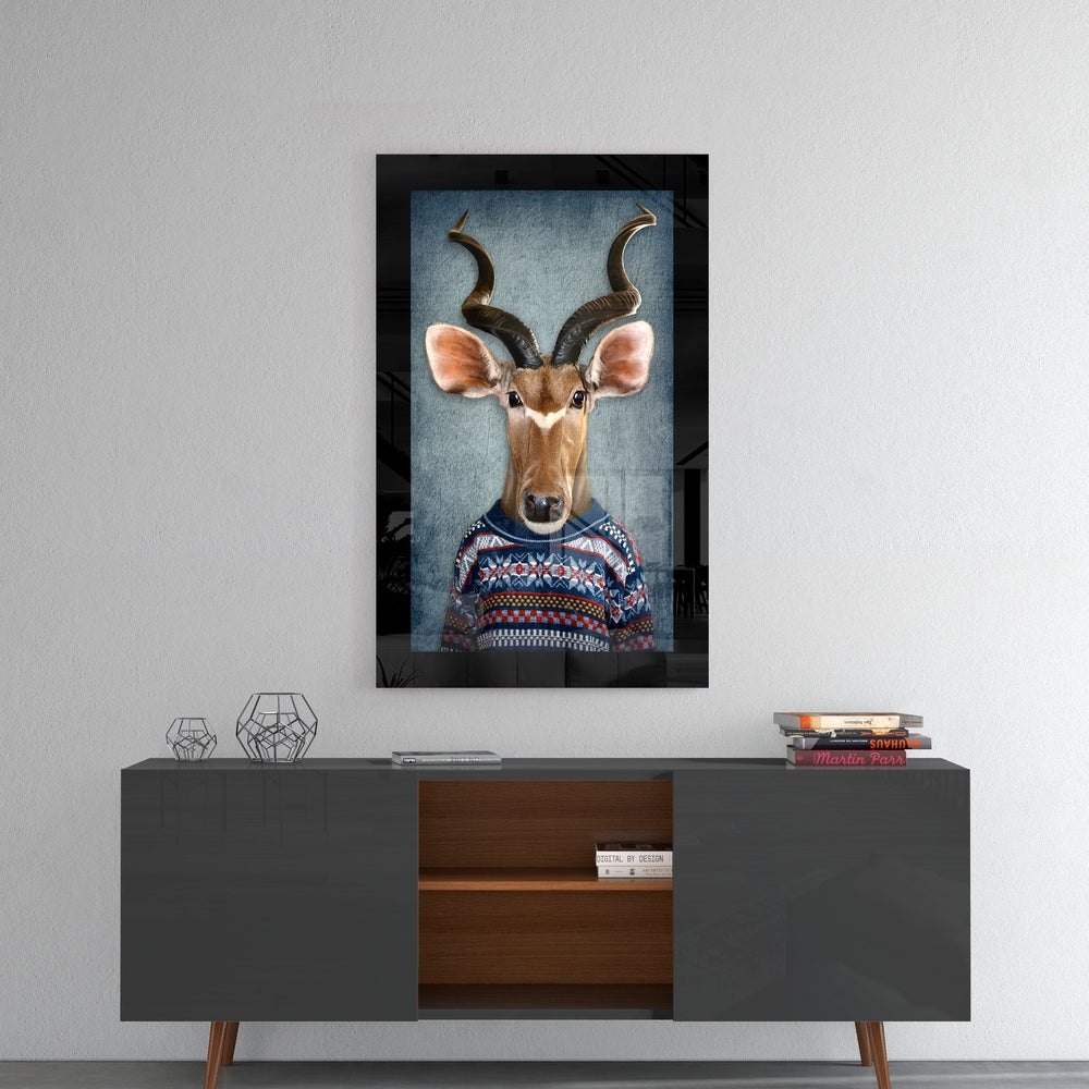 Framed glass wall art depicting an anthropomorphic deer wearing a patterned sweater, hung above a mid-century modern sideboard with decorative accessories.
