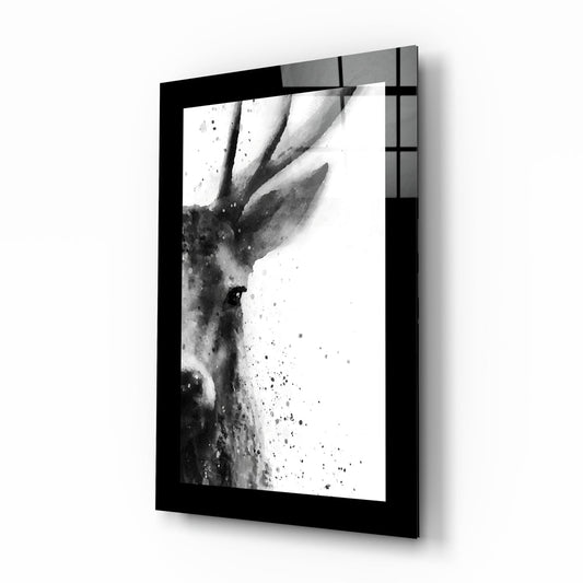 Black-framed glass wall art displaying monochromatic ink wash illustration of a stag's head in profile with splatter details.