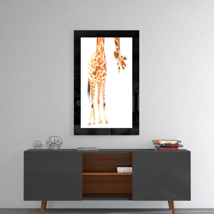 Framed glass wall art depicting a giraffe's rear view with spotted orange and tan coat hanging above a modern console table.