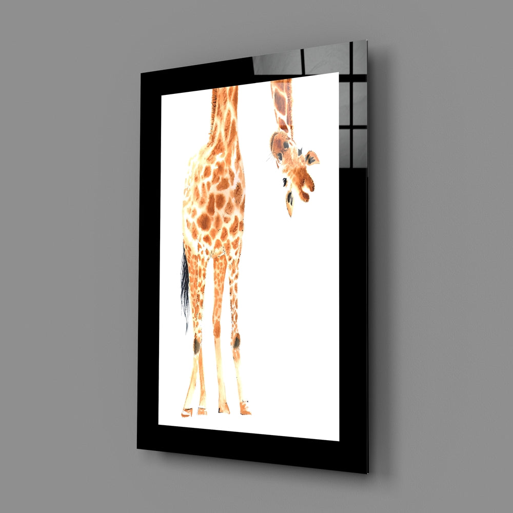 Black-framed glass wall art displaying an illustrated giraffe with orange and brown patterning viewed from behind, mounted at an angle.