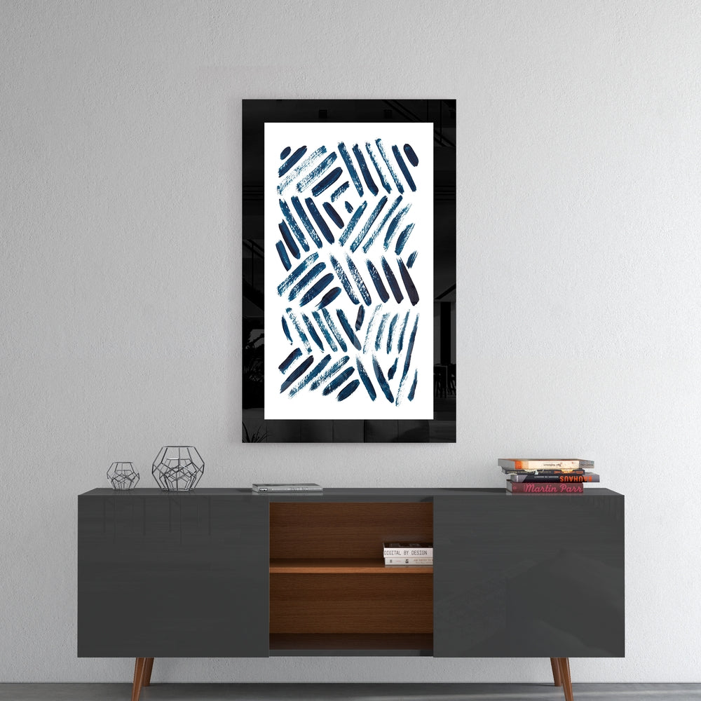 Black-framed blue striped glass wall art hanging above a gray mid-century console table with wooden shelving and decorative objects.