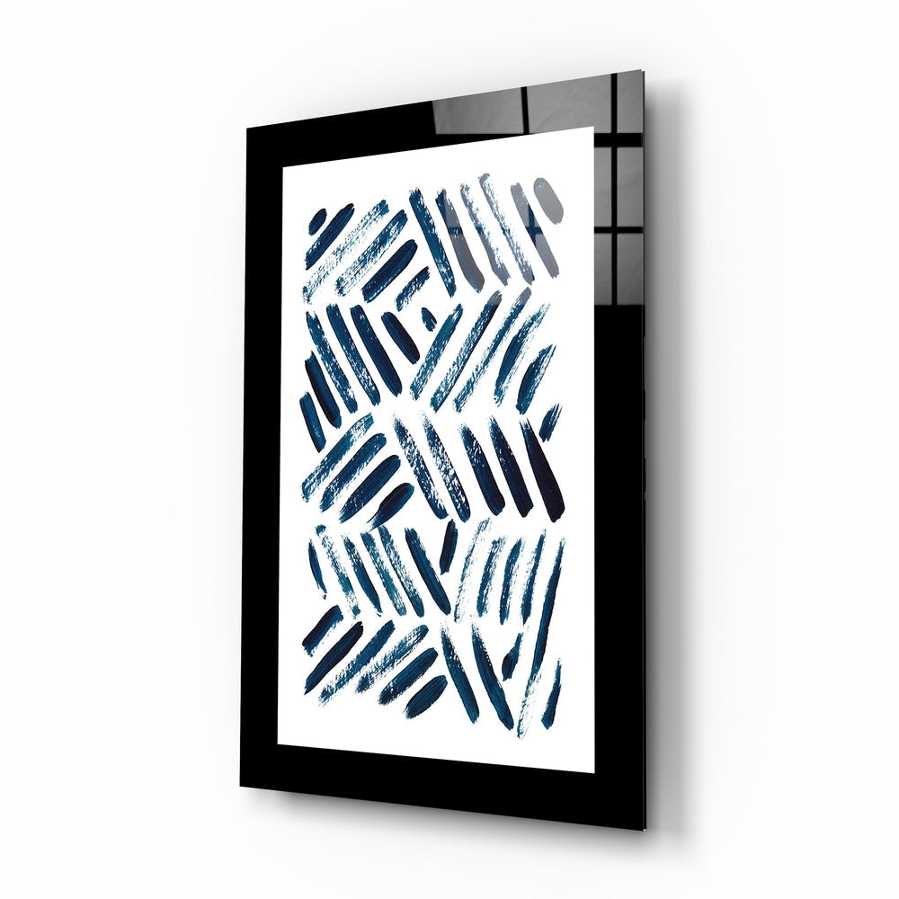 Black-framed glass wall art displaying diagonal blue brushstrokes on white background, mounted at an angle showing depth and shadow.