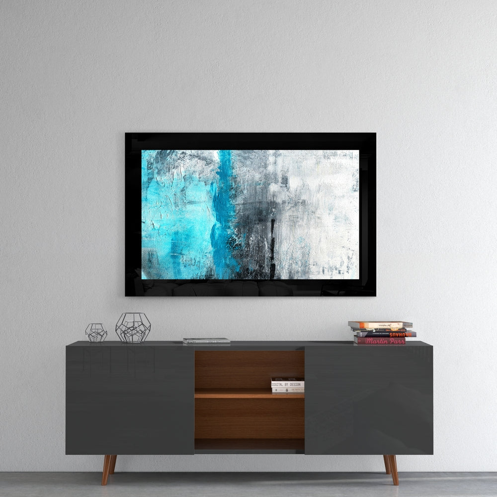 Abstract blue and white glass wall art mounted above a mid-century modern credenza in a minimalist interior setting.