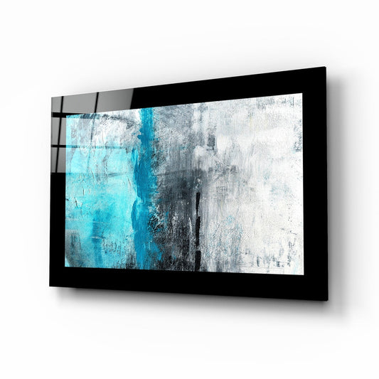 Black-framed glass wall art displaying abstract blue and grey textured design, mounted at an angle.