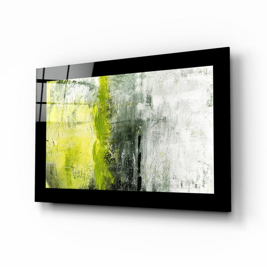Black-framed glass wall art mounted at an angle, displaying lime yellow, gray, and white textured abstract composition.