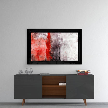 Black-framed abstract wall art displaying red, gray, and white brushstrokes hung above a mid-century modern credenza.