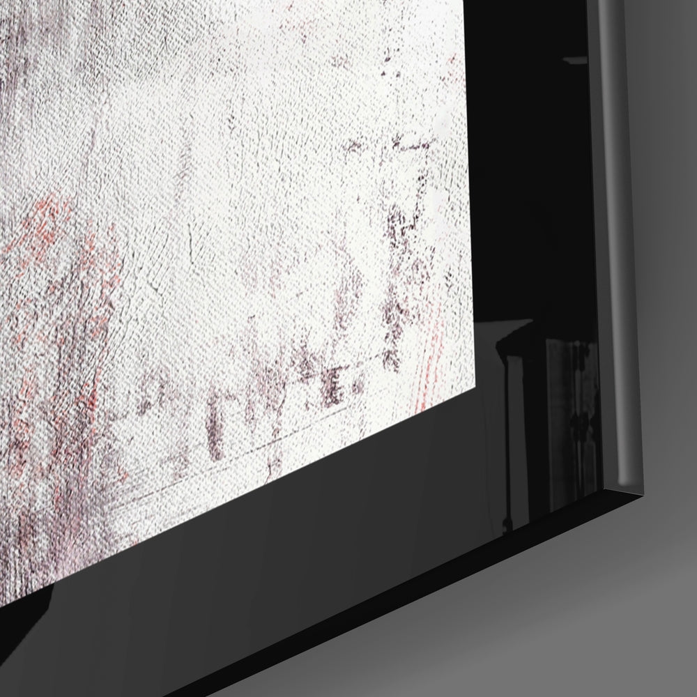 Close-up angled view of red and white textured glass wall art mounted in black frame against gray wall.