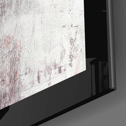 Close-up angled view of red and white textured glass wall art mounted in black frame against gray wall.