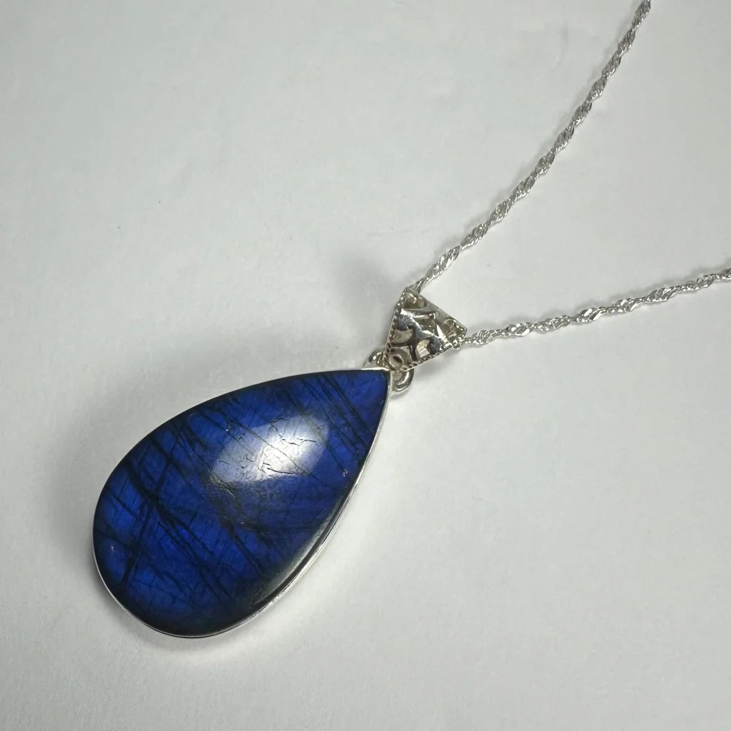 Deep blue labradorite teardrop pendant on silver chain