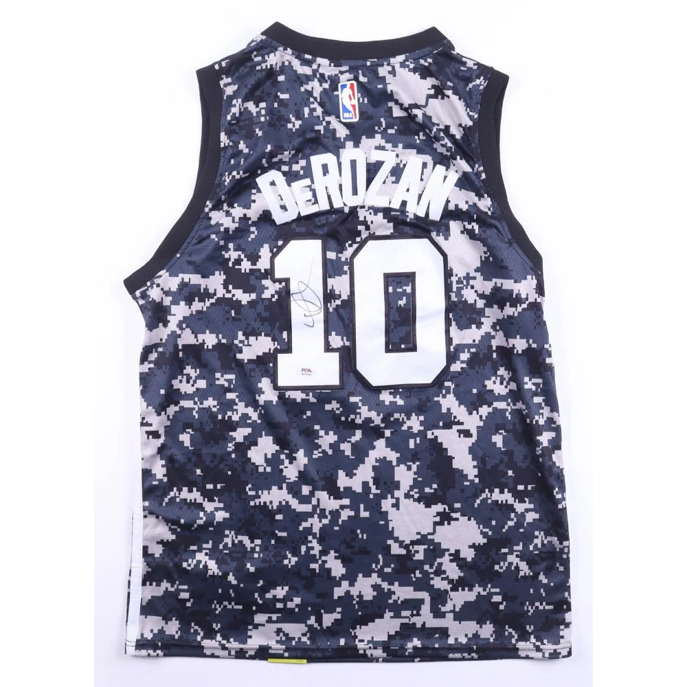 DeMar DeRozan #10 camo basketball jersey displayed in signed Spurs jersey with PSA auth