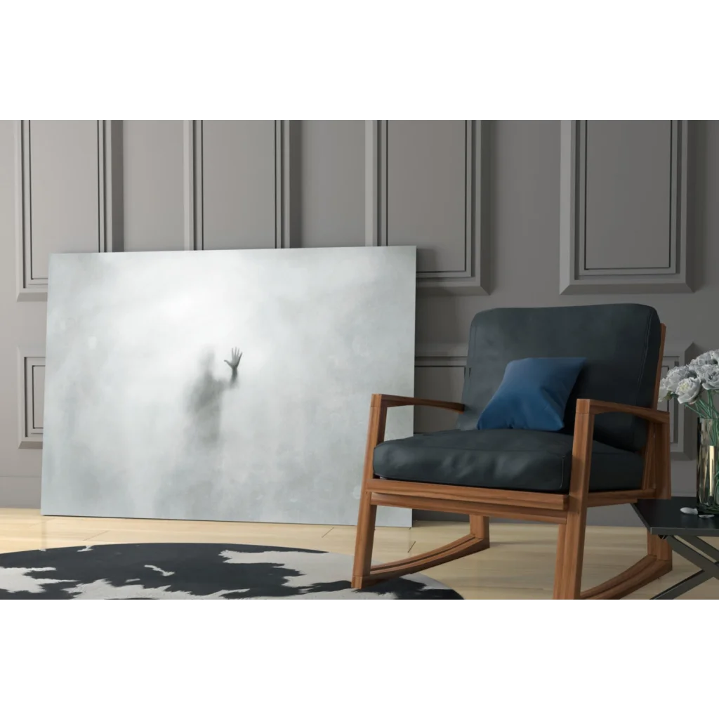 Dark blue rocking chair with wooden frame under Ethereal Hand Silhouette glass wall art