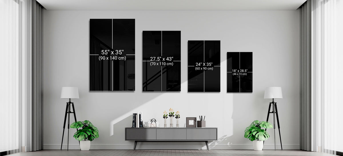 Four black glass wall art panels of decreasing size displayed horizontally above a console table, with size dimensions labeled in inches and centimeters.