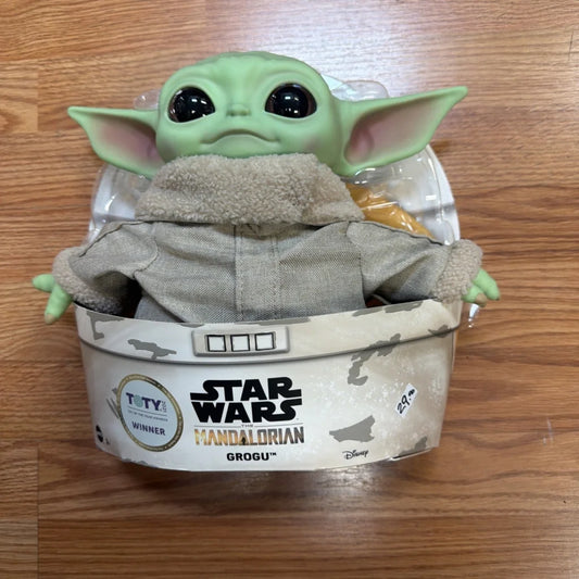 Disney Star Wars Grogu action figure in green plush with gray jacket in box