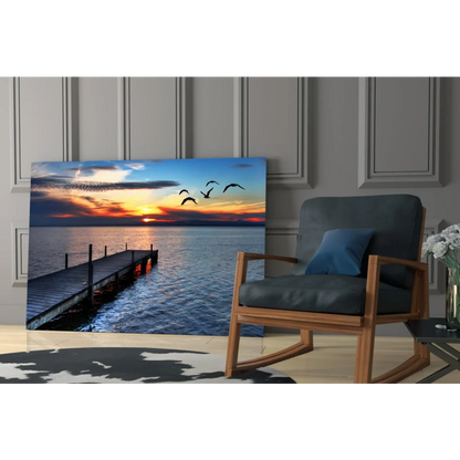 Serene sunset glass wall art with flying birds over water