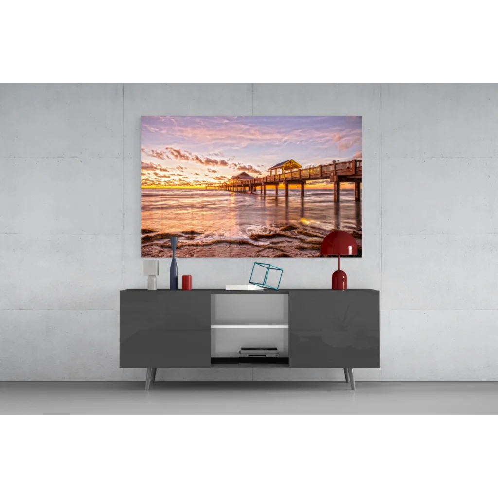 Vibrant sunset pier glass wall art canvas print with orange pink skies on water
