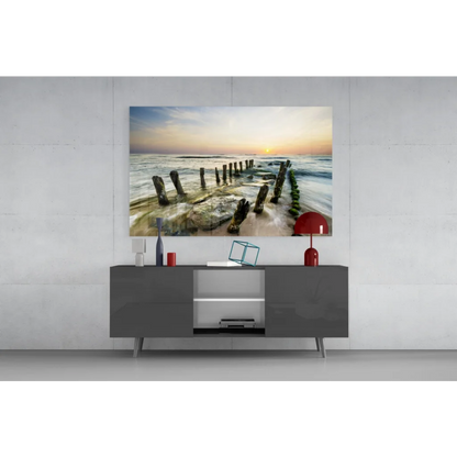 Serene sunset beach glass wall art with wooden pilings