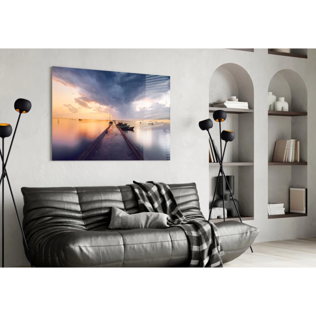 Black leather sofa with quilted texture and plaid throw in sunset marina glass wall art