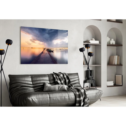 Black leather sofa with quilted texture and plaid throw in sunset marina glass wall art