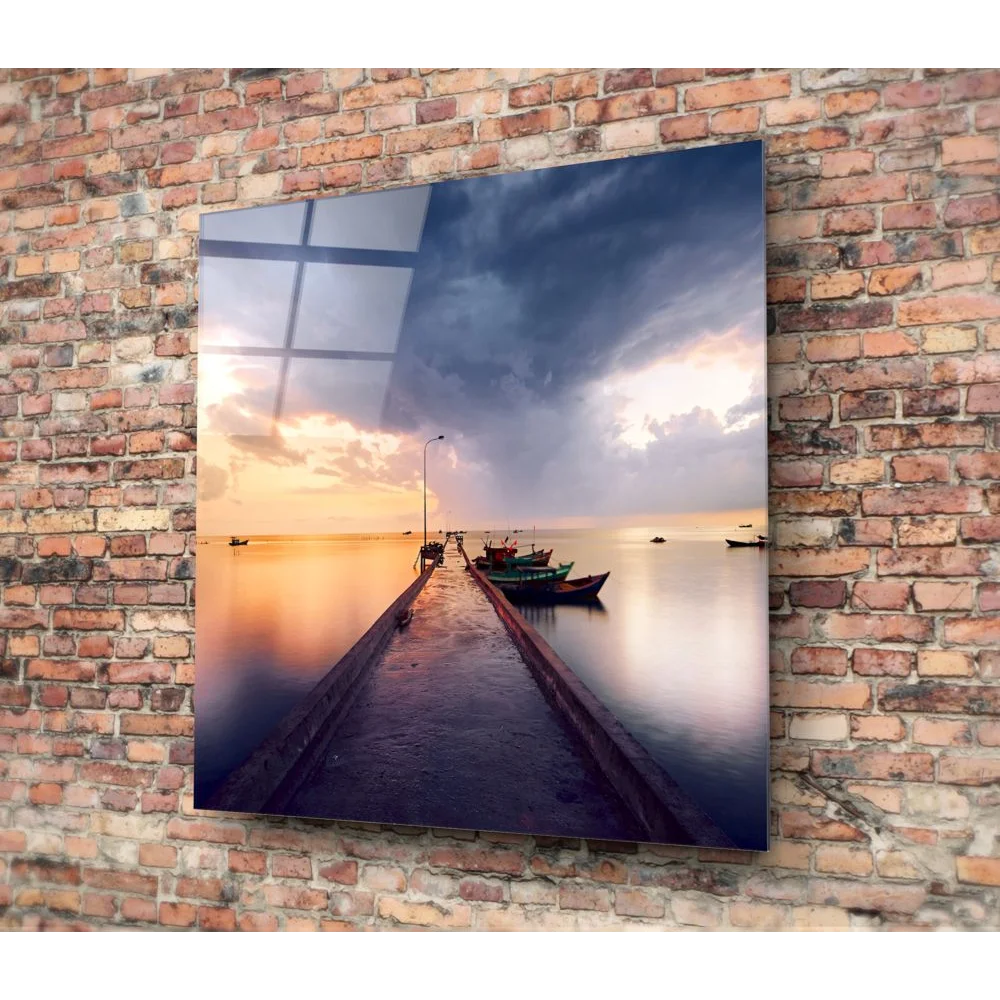 Stunning tempered glass art of coastal sunset with boats on calm water against brick wall
