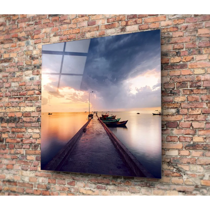 Stunning tempered glass art of coastal sunset with boats on calm water against brick wall