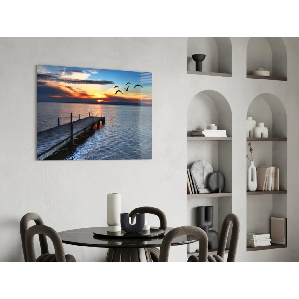 Serene sunset over water in Sunset Pier glass wall art with flying birds