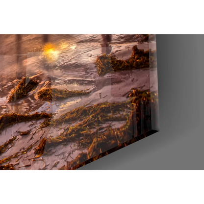 Sleek glass wall art of serene sunset pier with golden sunlight on wet sand