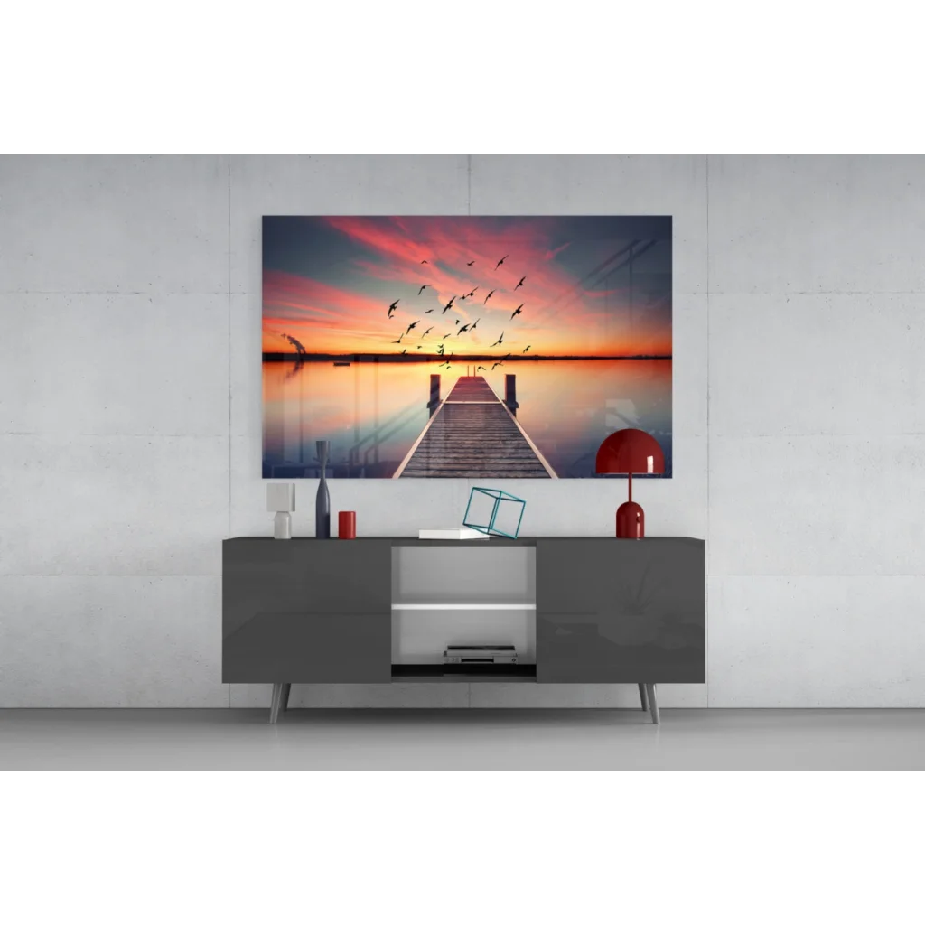 Vibrant sunset glass wall art print of pier and silhouetted birds