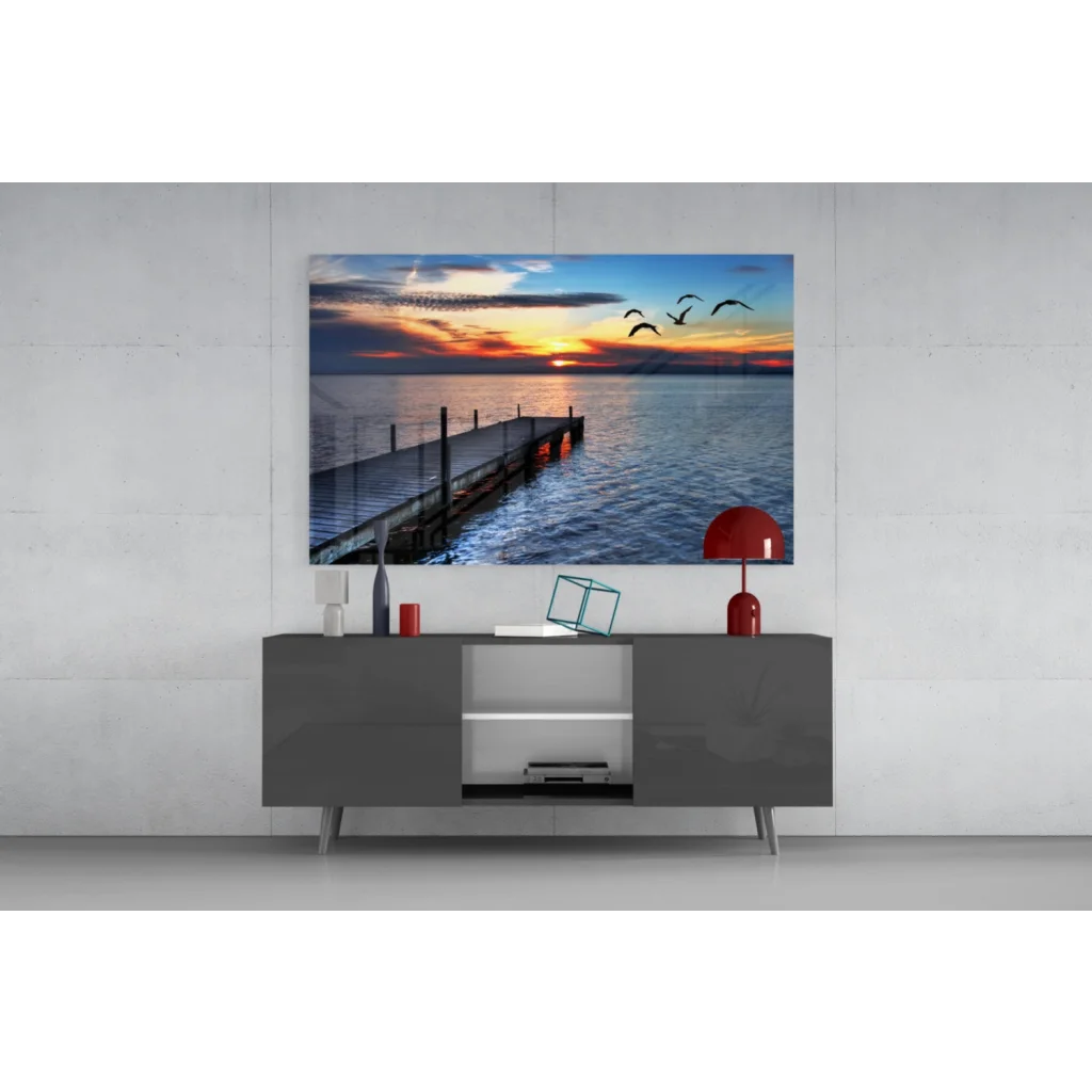 Vibrant sunset glass wall art with birds over pier and calm waters