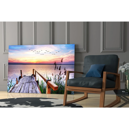 Serene sunset glass wall art with dock, reeds and birds