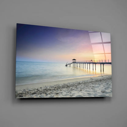 Beige beach glass wall art with pier in calm waters under purple-orange sky