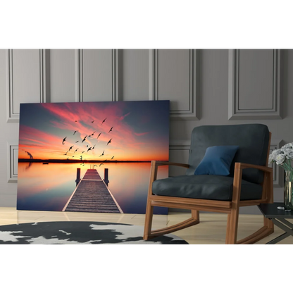 Vibrant sunset glass wall art print of pier and birds in flight