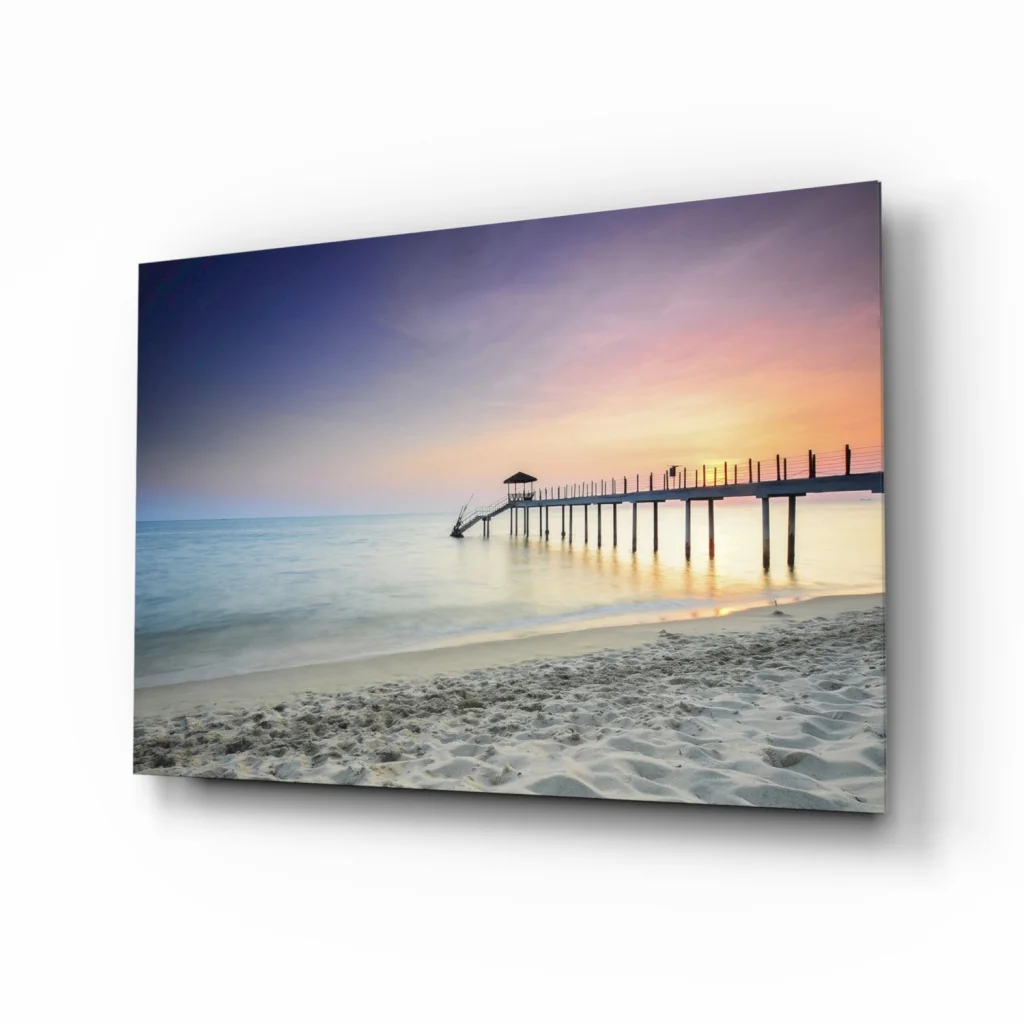 Stunning glass wall art of beach sunset pier in calm waters