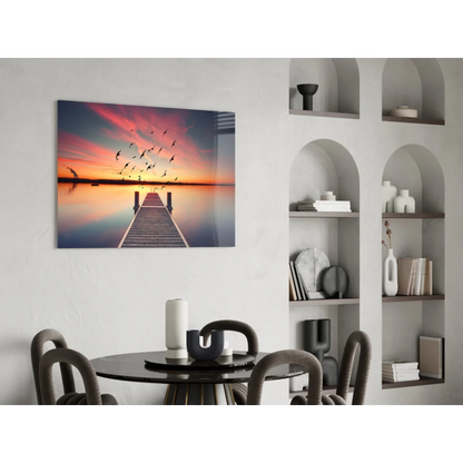 Serene glass wall art print of sunset over water with birds on white wall