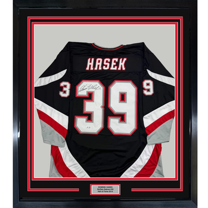Framed Autographed/Signed Dominik Hasek 35x39 Buffalo Black Hockey Jersey Beckett BAS COA