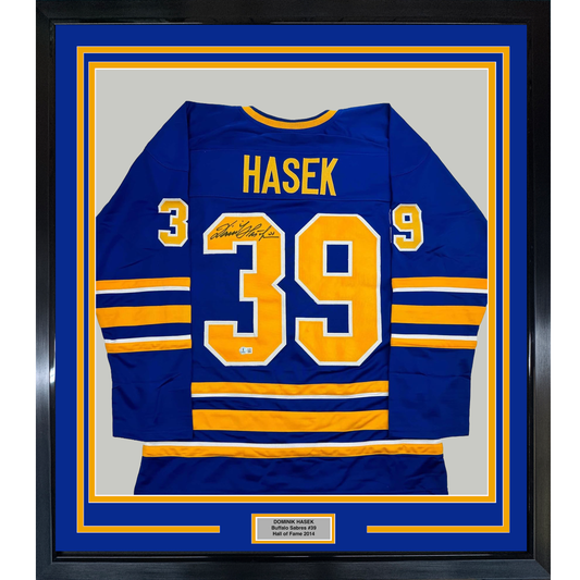 Framed front view of autographed navy blue Buffalo Sabres hockey jersey number 39 with gold and white lettering and horizontal stripes.
