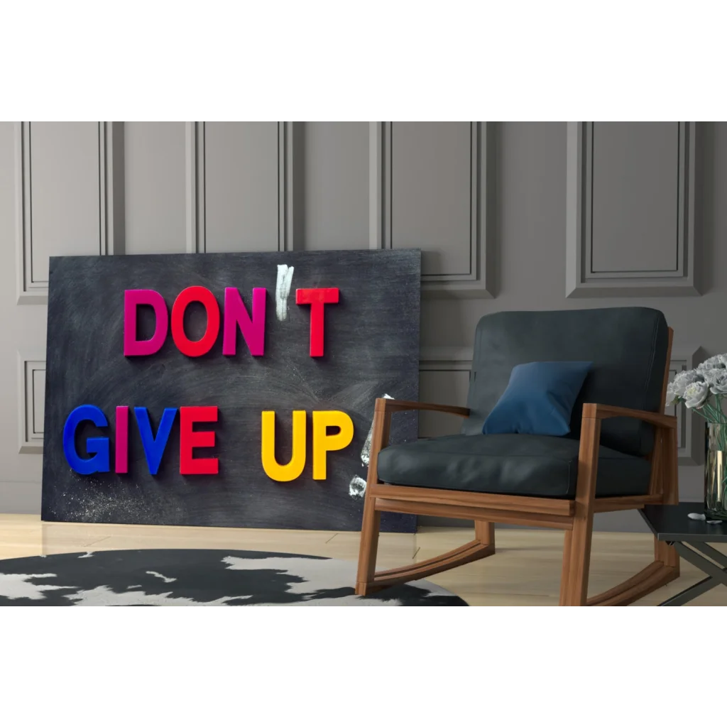 Vibrant 3D glass wall art Don’t Give Up sign in bold pink red blue yellow letters on dark gray canvas