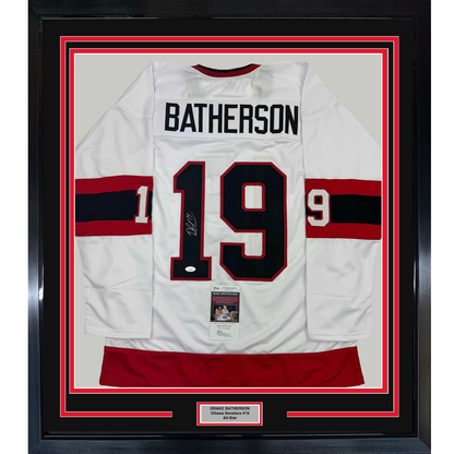 Framed white Ottawa Senators hockey jersey #19 with "BATHERSON" nameplate, signed, displayed front-facing with red and black striped trim and JSA authentication certificate visible.