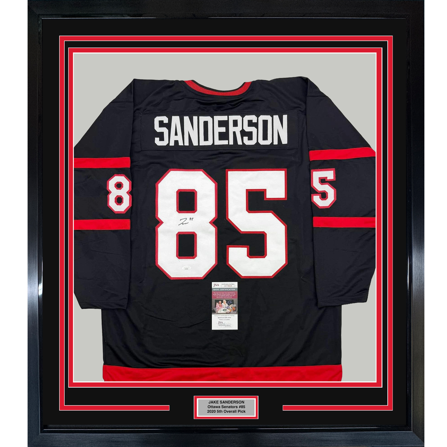 Black hockey jersey with red and white trim displaying "SANDERSON" and number "85" in white, framed with red and black matting and JSA authentication certificate visible at bottom.