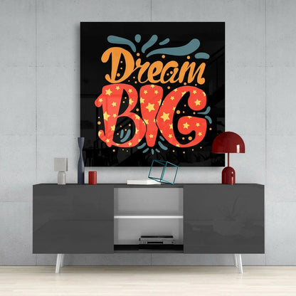 Dream big glass wall art with bold orange lettering and yellow stars