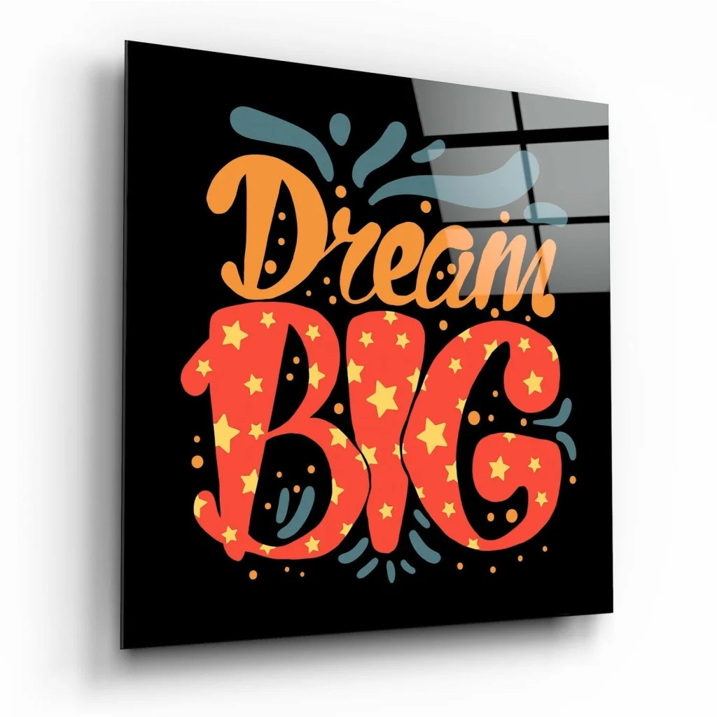 Vibrant dream big glass wall art with bold orange red lettering and yellow stars on glossy black background