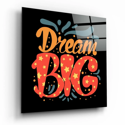 Vibrant dream big glass wall art with bold orange red lettering and yellow stars on glossy black background