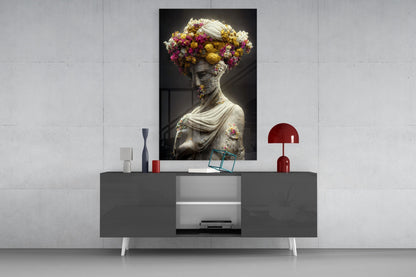 Floral-adorned classical statue portrait displayed on a wall above a modern dark console table with red accents.